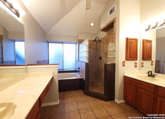 bathroom featuring shower with separate bathtub, vaulted ceiling, tile patterned floors, and vanity