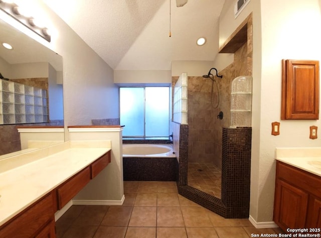 bathroom featuring lofted ceiling, vanity, a textured ceiling, tile patterned floors, and separate shower and tub