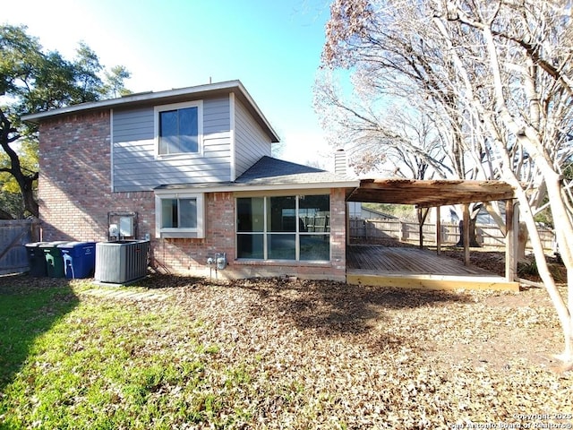 back of house with cooling unit, a wooden deck, and a pergola