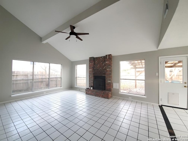 unfurnished living room with light tile patterned floors, a wealth of natural light, a fireplace, and high vaulted ceiling