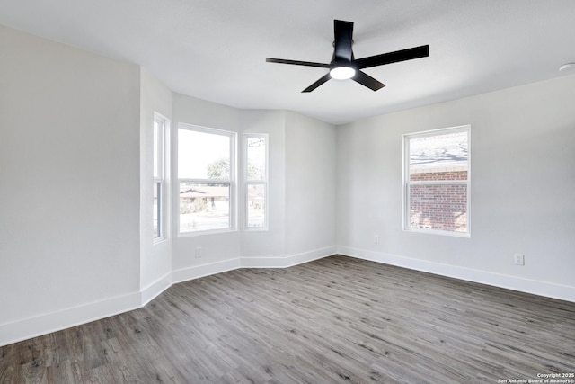 empty room with hardwood / wood-style floors and ceiling fan