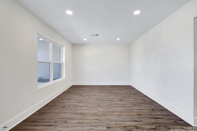 spare room featuring dark hardwood / wood-style floors