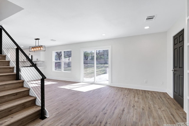 interior space featuring wood-type flooring and a chandelier