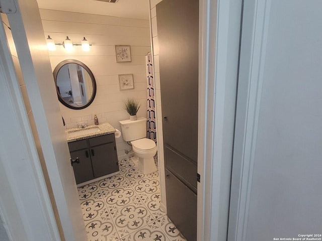 bathroom featuring tile patterned flooring, vanity, and toilet