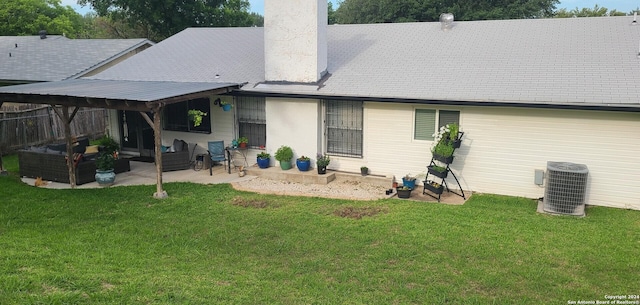 rear view of house featuring a yard, a patio, and central air condition unit