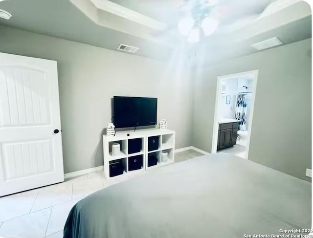 tiled bedroom featuring connected bathroom