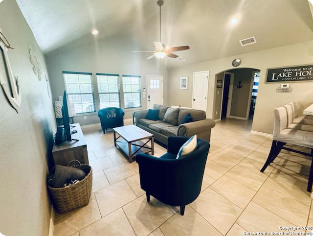 tiled living room featuring ceiling fan and high vaulted ceiling