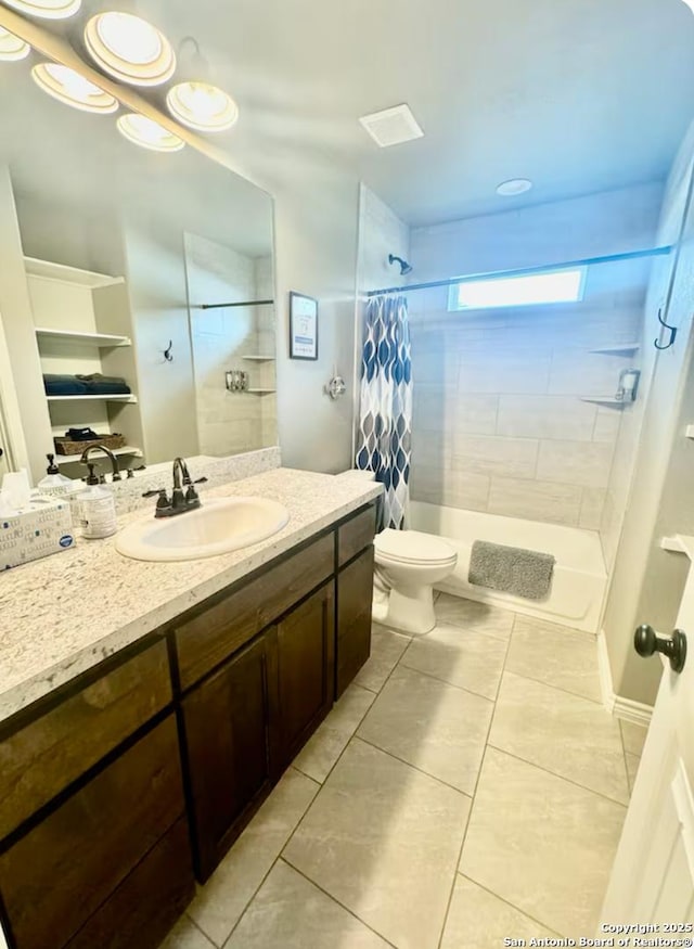 bathroom with tile patterned flooring, vanity, and toilet