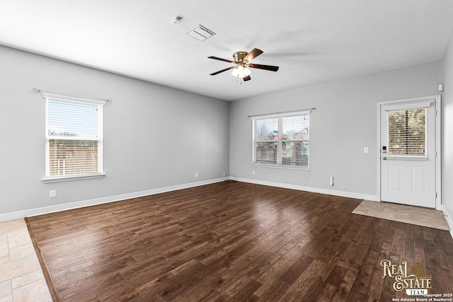 empty room with hardwood / wood-style floors and ceiling fan