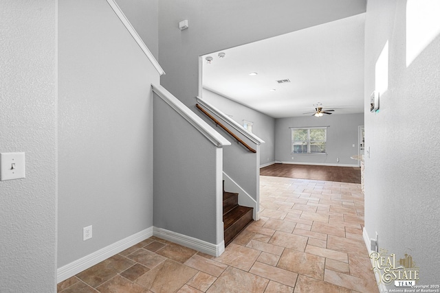 stairway with ceiling fan