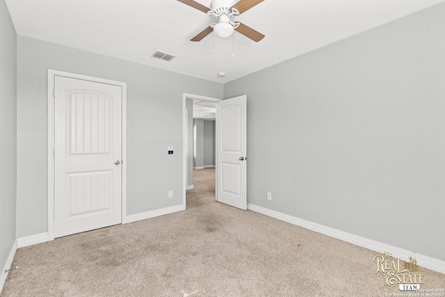 unfurnished bedroom featuring ceiling fan and light carpet