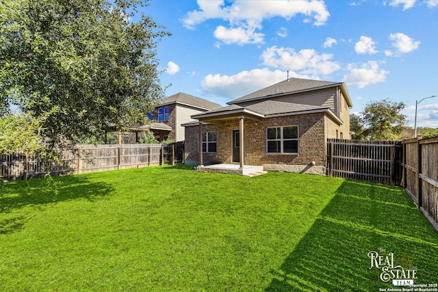 back of property featuring a lawn and a patio