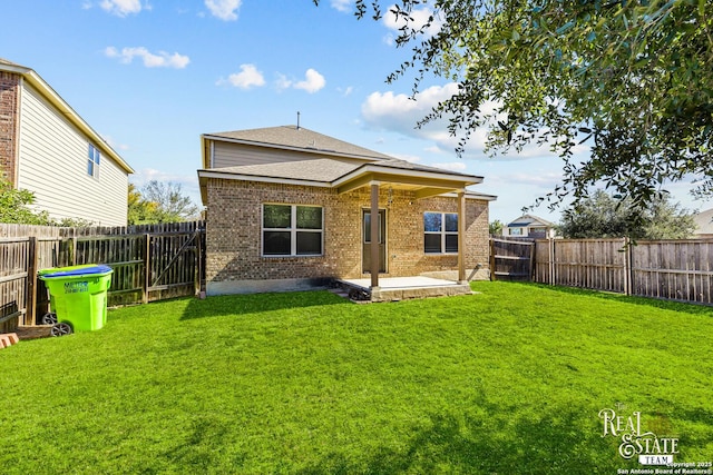 rear view of house with a lawn and a patio area