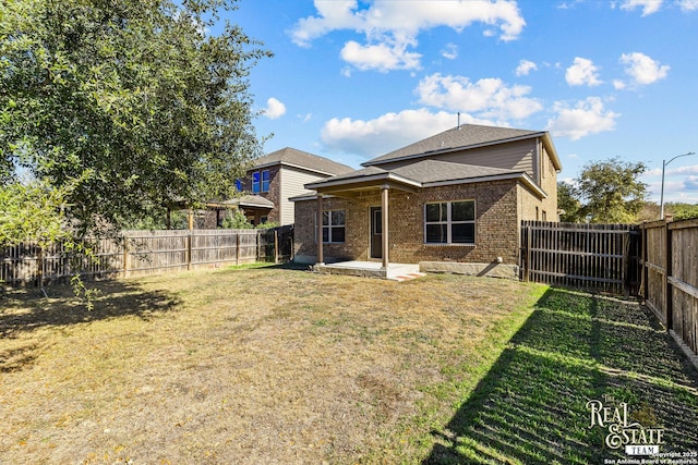 back of house featuring a patio and a lawn