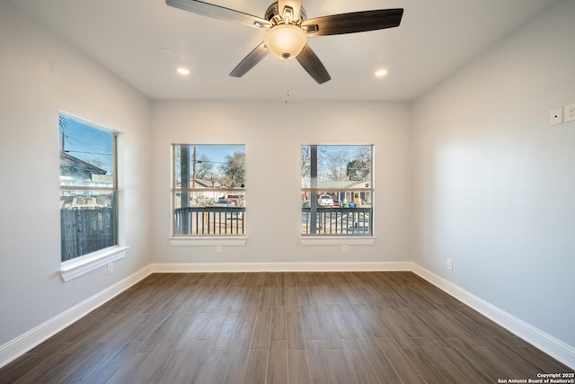 empty room with dark hardwood / wood-style floors and ceiling fan