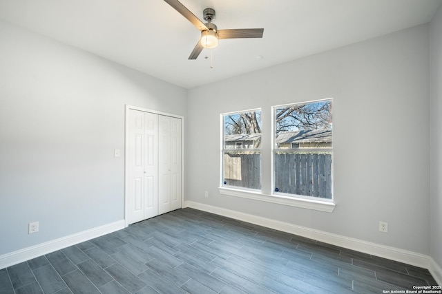 unfurnished bedroom with ceiling fan, dark hardwood / wood-style floors, and a closet