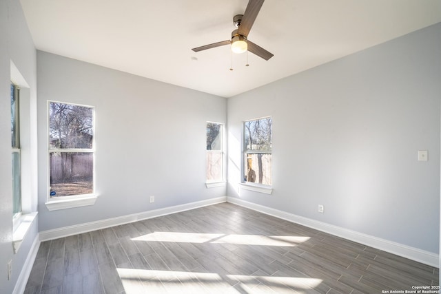 empty room with ceiling fan and dark hardwood / wood-style floors