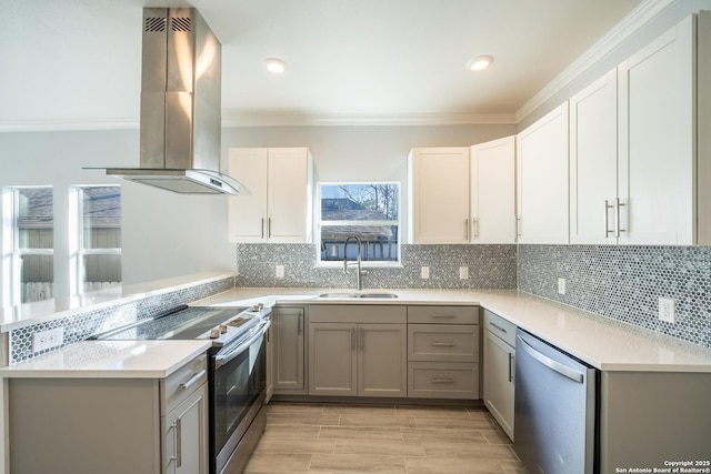 kitchen featuring white cabinetry, sink, island exhaust hood, kitchen peninsula, and stainless steel appliances