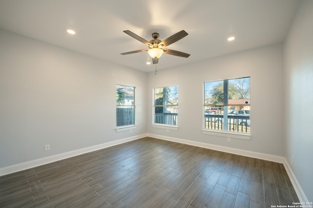 spare room with dark wood-type flooring and ceiling fan