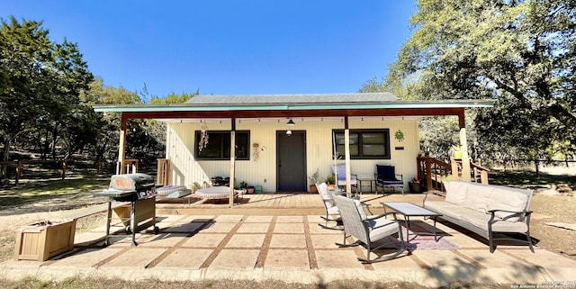 rear view of property with an outdoor hangout area and a patio area