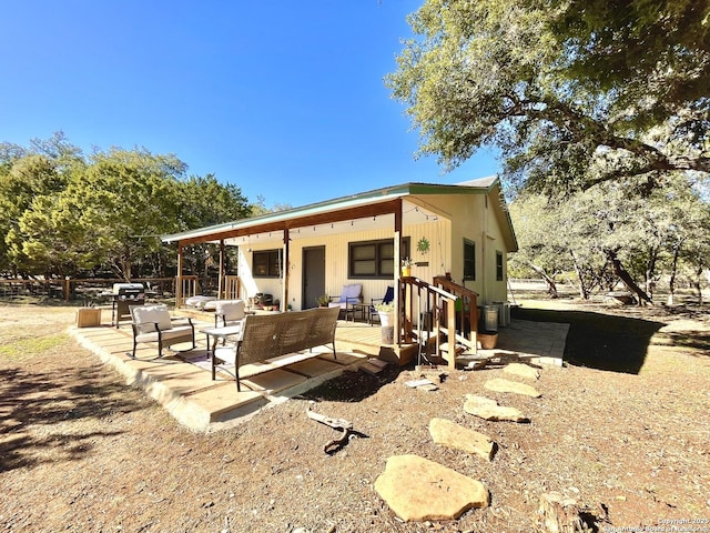 rear view of house with outdoor lounge area