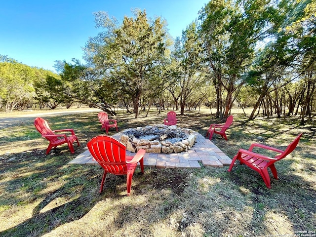 view of yard featuring an outdoor fire pit and a patio