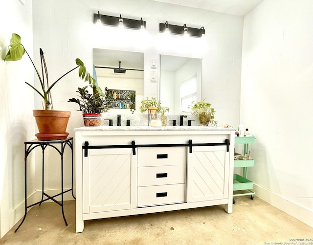 bathroom with vanity and concrete floors