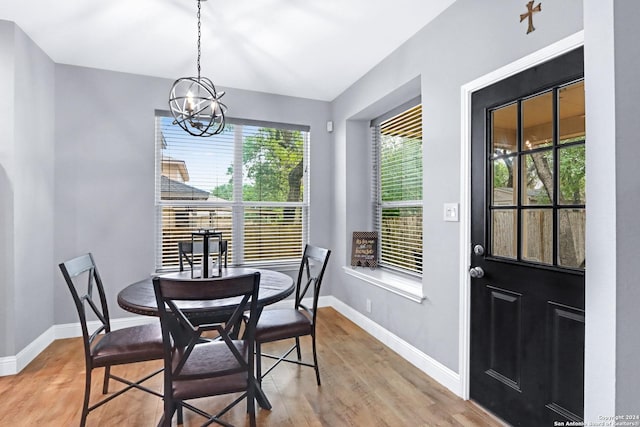 dining area featuring a notable chandelier and hardwood / wood-style flooring