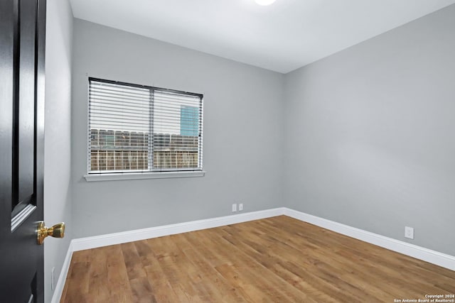 empty room with hardwood / wood-style flooring