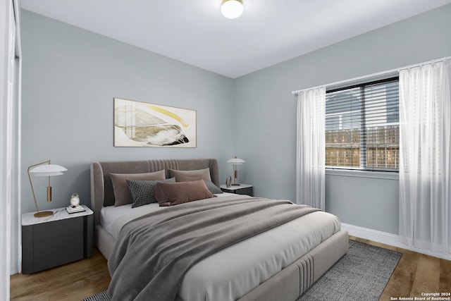 bedroom with hardwood / wood-style flooring