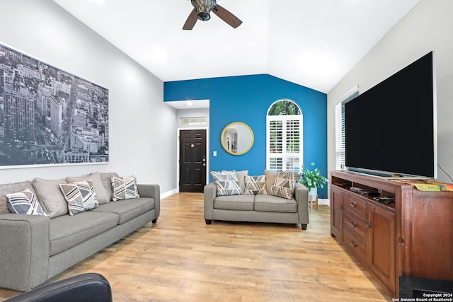 living room featuring ceiling fan, lofted ceiling, and light hardwood / wood-style floors