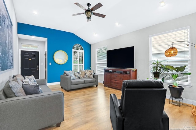 living room featuring vaulted ceiling, ceiling fan, and light wood-type flooring