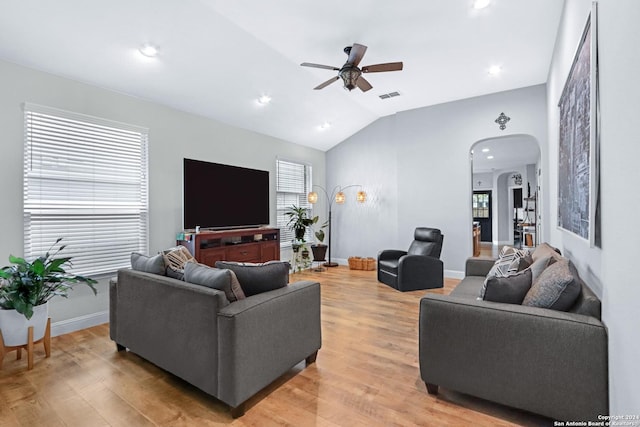 living room featuring lofted ceiling, light hardwood / wood-style floors, and ceiling fan