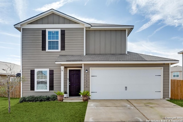 view of front of house featuring a garage and a front lawn