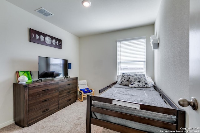 bedroom featuring light colored carpet