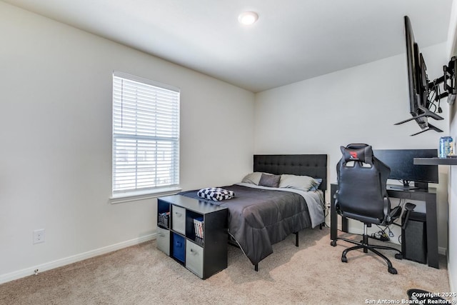 bedroom featuring light colored carpet