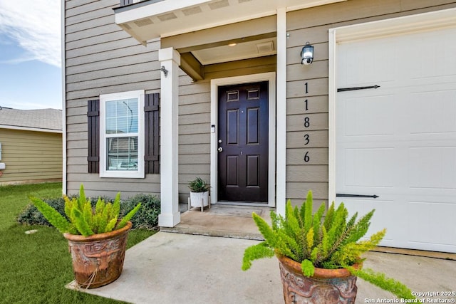 view of exterior entry featuring a garage