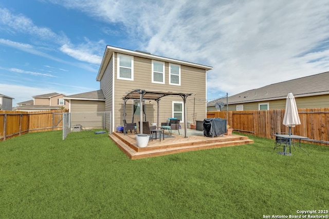 rear view of property featuring a wooden deck, a pergola, and a lawn