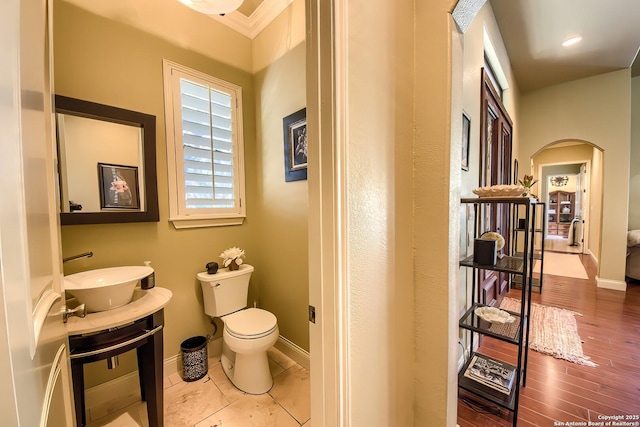 bathroom with sink, hardwood / wood-style floors, and toilet