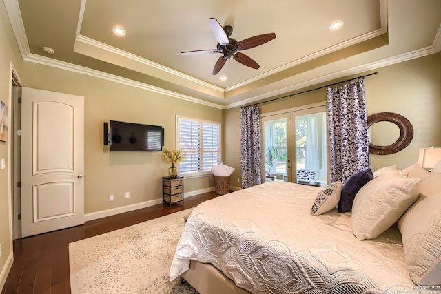 bedroom with ornamental molding, dark hardwood / wood-style flooring, a raised ceiling, and access to outside