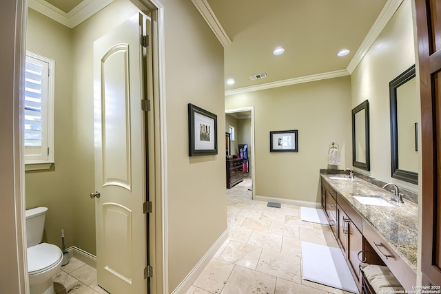 bathroom with ornamental molding, vanity, and toilet