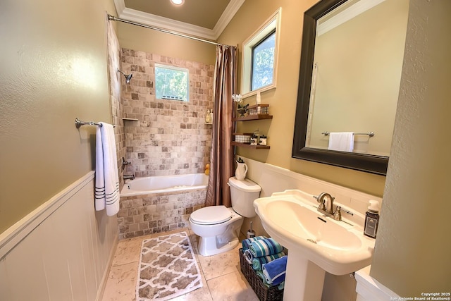 full bathroom featuring sink, crown molding, tile patterned flooring, toilet, and shower / bath combo with shower curtain