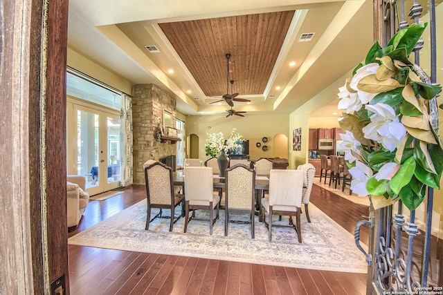 dining room featuring french doors, wood-type flooring, wooden ceiling, a raised ceiling, and ceiling fan