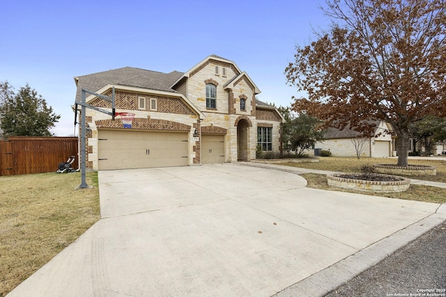 view of front facade with a garage and a front lawn