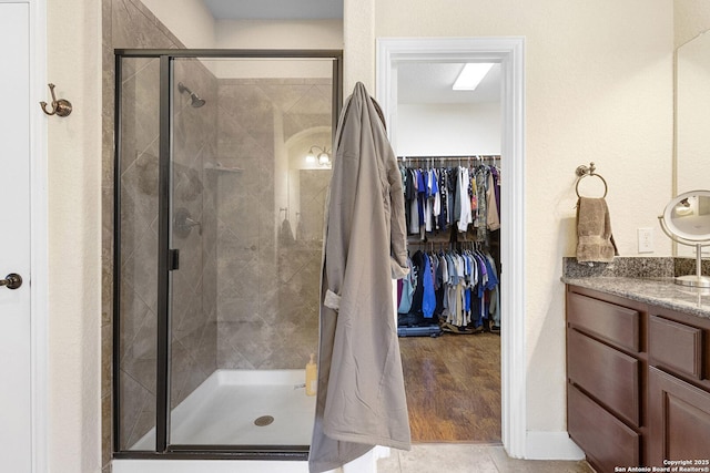 bathroom featuring vanity and a shower with shower door