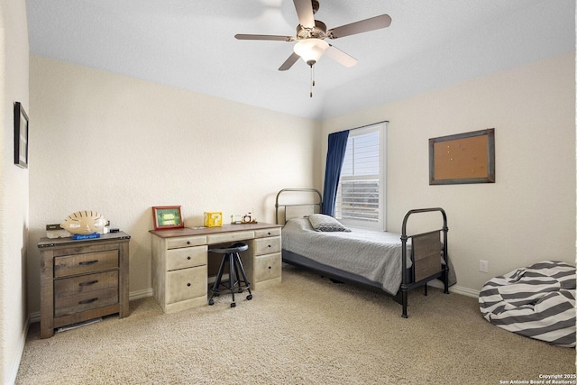 bedroom featuring vaulted ceiling, light colored carpet, and ceiling fan