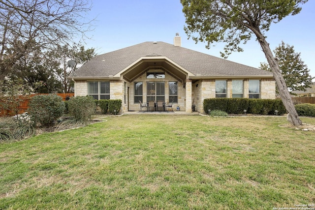 rear view of house featuring a lawn