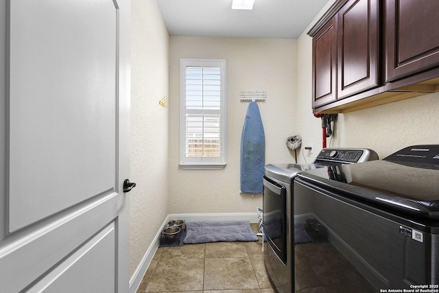 clothes washing area with cabinets, light tile patterned flooring, and separate washer and dryer