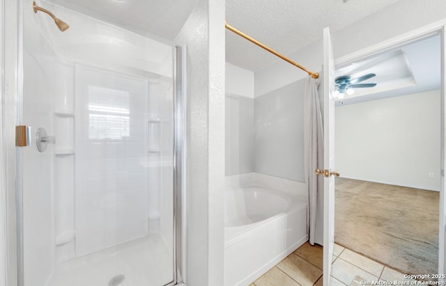 bathroom with tile patterned flooring, ceiling fan, independent shower and bath, and a textured ceiling