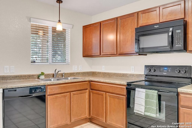 kitchen featuring pendant lighting, sink, and black appliances